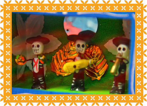 close up photo of handcrafted Mexican box with little skeletons with instruments inside