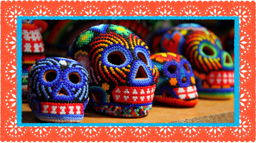 photo of four colorful handbeaded Mexican skulls